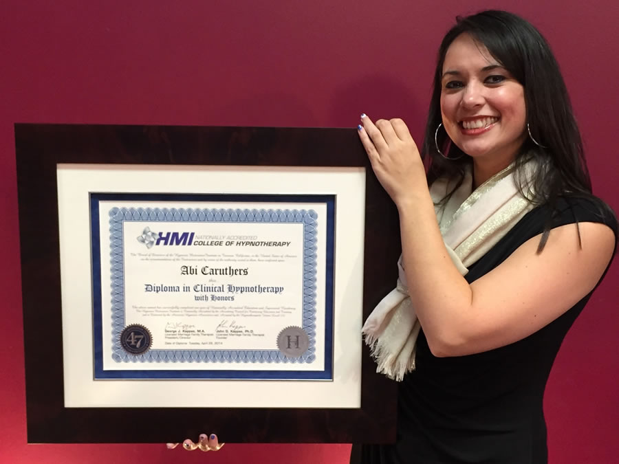 Abi Caruthers Holding Diploma